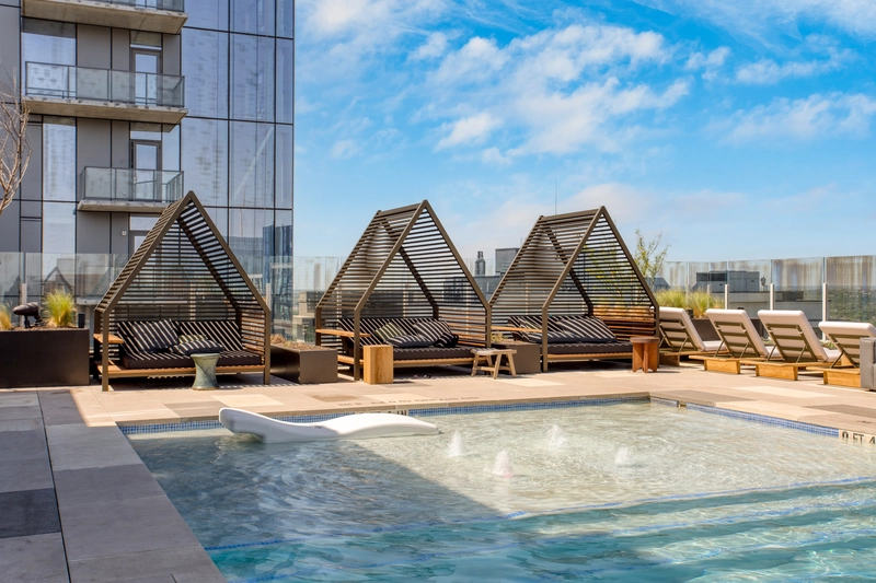 3 triangle shade loungers by the roof top pool with blue skies making it the best austin airbnb